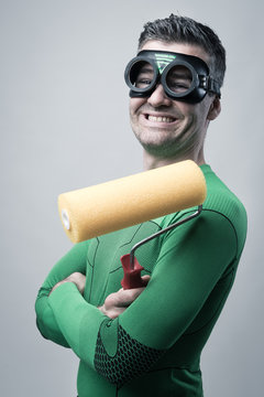 Funny superhero with painting roller