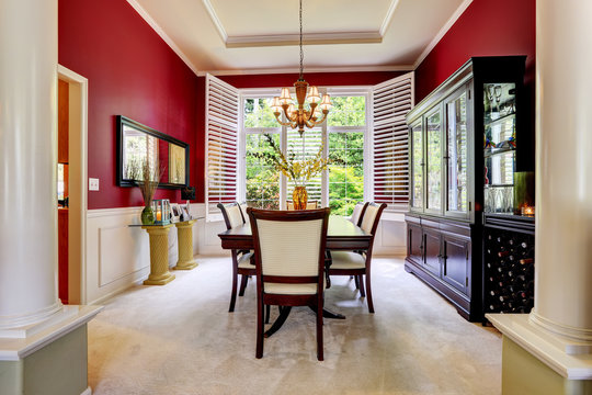 Luxury dining area with bright red wall