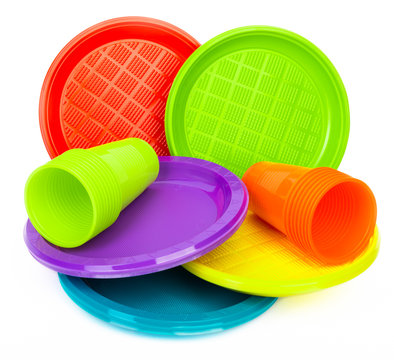 Disposable Bright Plastic Plates And Cups On White Background