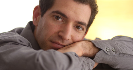 Fototapeta premium Businessman lying down and looking at camera