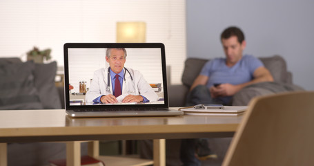Fototapeta na wymiar Doctor giving advice via webcam