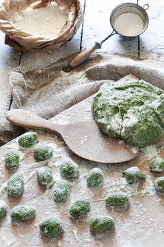 uncooked homemade spinach dumplings with dough