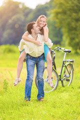 Happy and Cheerful Young Couple Piggyback Having Fun Outdoors