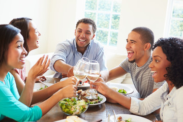 Group Of Friends Enjoying Meal At Home Together