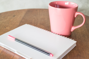 Notepaper and hot drink on wooden table