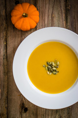 Pumpkin soup on wooden background