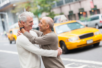 Gay Couple with Traffic on Background in New York