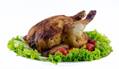Whole roasted chicken garnished with fresh cucumbers, wine tomat