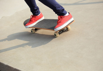 skateboarding woman legs at skatepark 