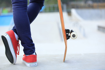 Fototapeta na wymiar skateboarder woman legs at skatepark