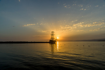 Evening. Sailboat in the bay.