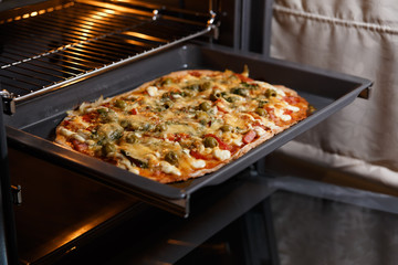 Baking pizza in oven.