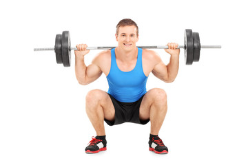 Fototapeta na wymiar Young sportsman lifting a heavy weight