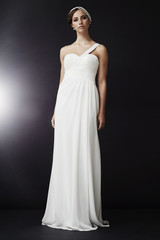 Fototapeta premium Elegant young woman in white dress, portrait.