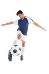 Fit player kicking football