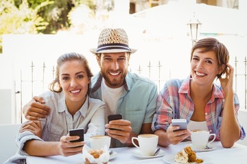 Happy friends enjoying coffee together