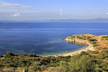 Fototapeta na wymiar Wild sandy beach in the beautiful bay of the Aegean Sea.
