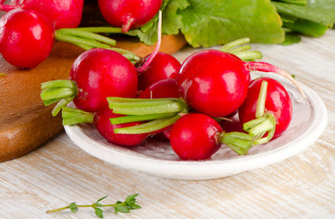 Radishes on   wooden board.