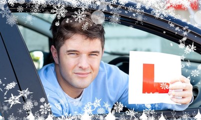 Composite image of positvie young male driver holding a l sign