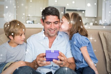 Composite image of loving children gifting father