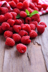 Ripe sweet raspberries on table close-up