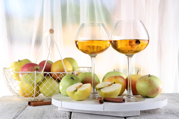 still life with apple cider and fresh apples on wooden table