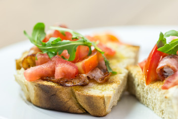 Fresh Bruschetta Sandwich With Bacon, Rucola And Tomatoes