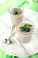 Delicious berry mousse in glasses on table close-up