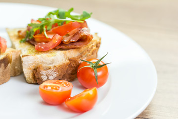 Fresh Bruschetta Sandwich With Bacon, Rucola And Tomatoes