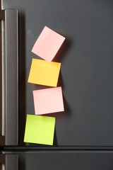 Note on piece of paper on refrigerator closeup