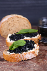 Slices of bread with butter and black caviar