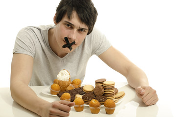 Man in love with sweets, candies,chocolate and sugar, abstain