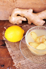 Cup of ginger drink and lemon