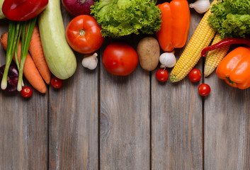 Fresh organic vegetables on wooden background