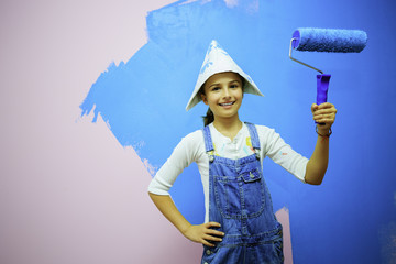 Renovation of the house - young girl  painting wall