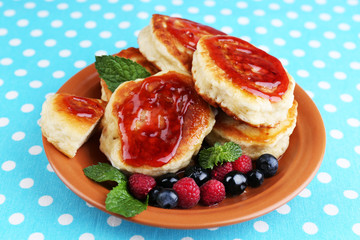 Tasty pancakes with fresh berries, jam and mint leaf