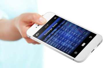 hand holding mobile phone with exchange rates screen isolated ov