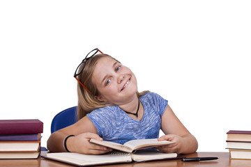 child at the table with books and school terms
