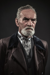 Fototapeta premium Vintage characteristic senior man with gray hair and beard. Stud