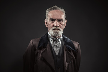 Obraz premium Vintage characteristic senior man with gray hair and beard. Stud