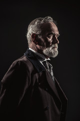 Vintage characteristic senior man with gray hair and beard. Stud
