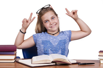 child at the table with books and school terms