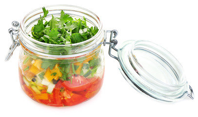 Vegetable salad in glass jar, isolated on white