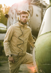 Young pilot posing near the helicopter