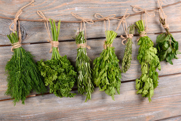Different fresh herbs on wooden background