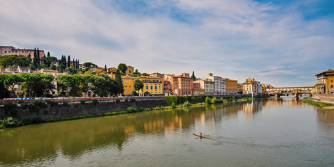 Fototapeta na wymiar Arno river and Ponte Vecchio (Old Bridge) in the background. Flo