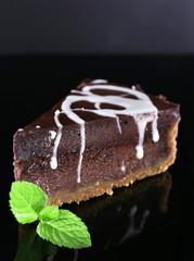 Piece of chocolate cake with mint leaves