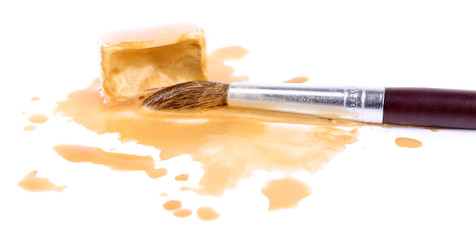 Watercolor paint cube with brush and spilled paint isolated