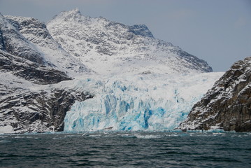 View of mountains and blue icebergs in Greenland