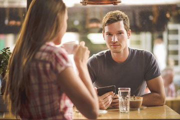 Young couple on first date drinking coffee
